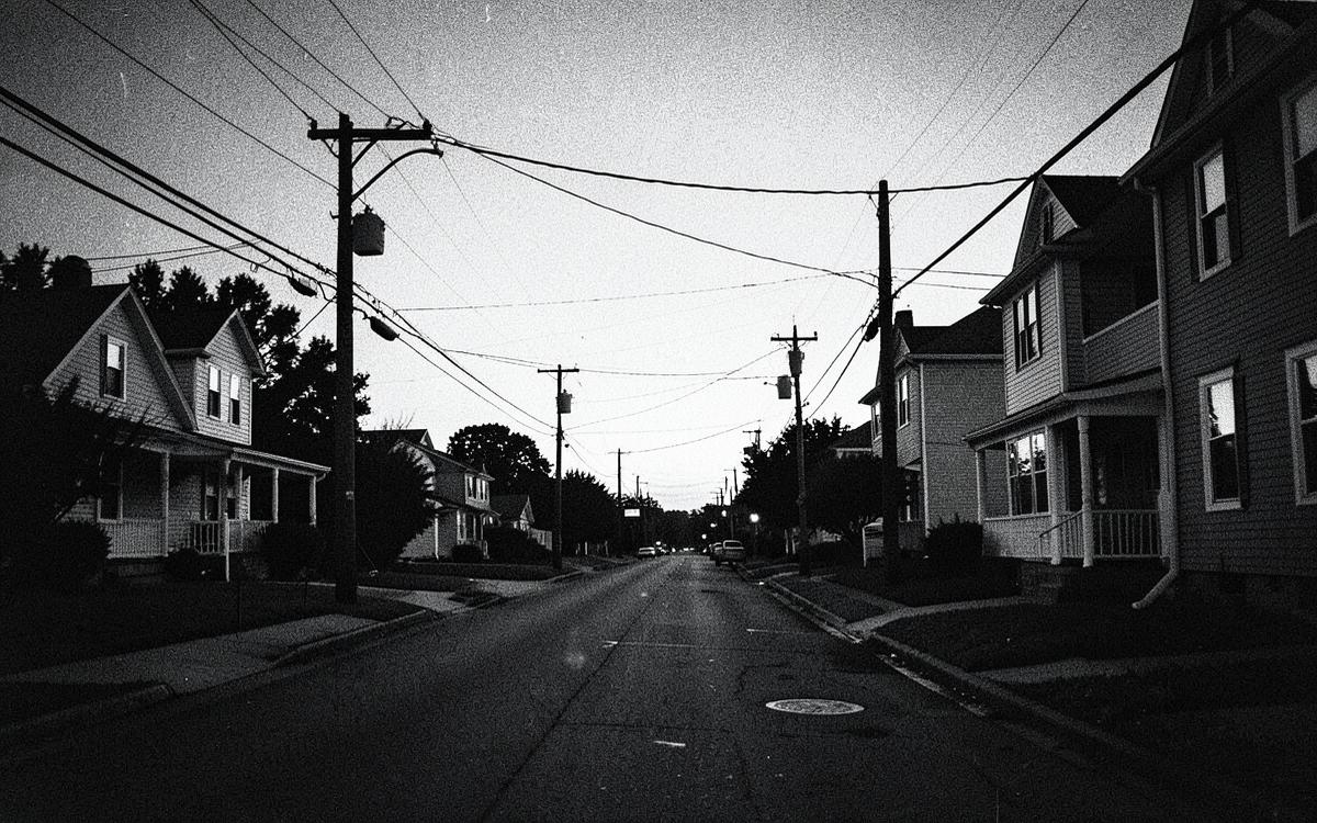 A quiet residential street of houses at dusk