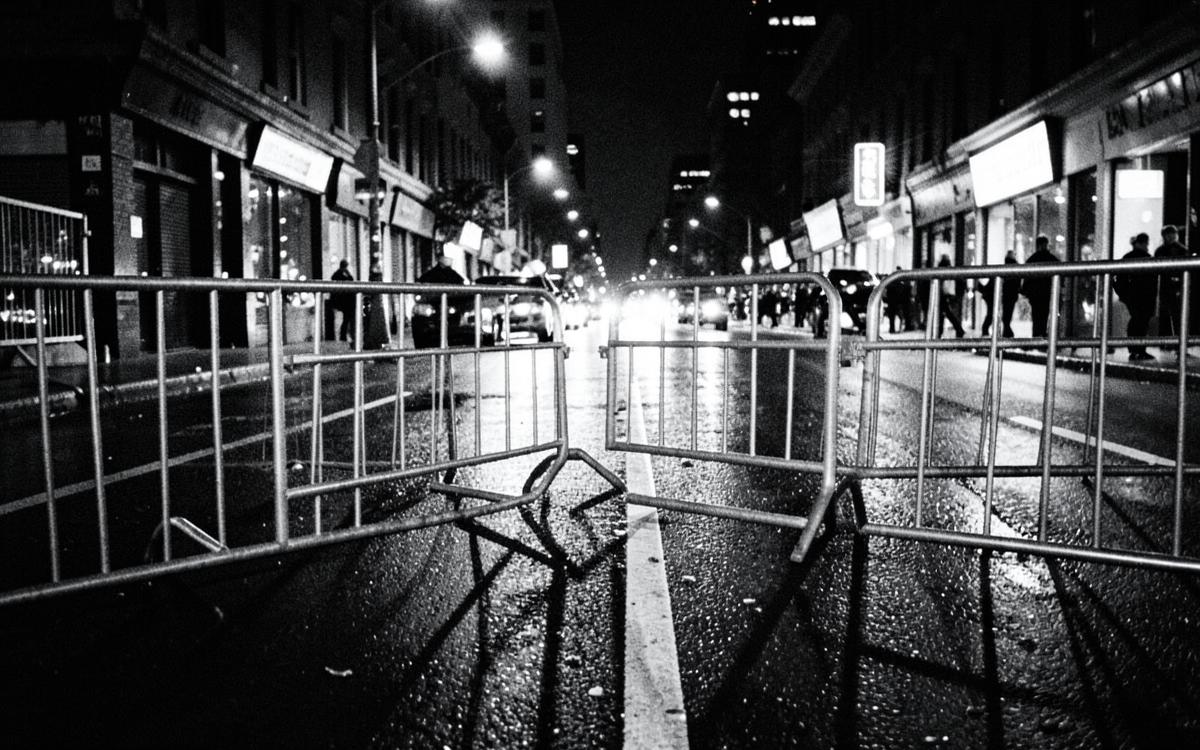 Police barricades on a wet night-time city street
